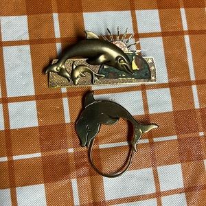 Brass and gold dolphin pins